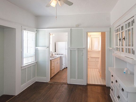 Dining room with cool built-in glass front cabinets; kitchen