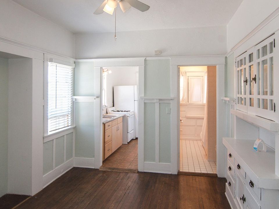 Dining room with cool built-in glass front cabinets; kitchen