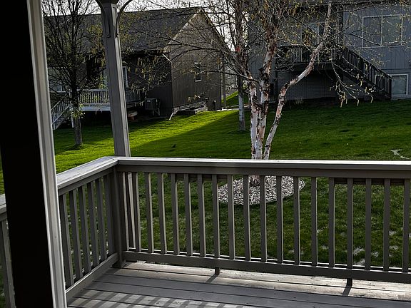 View from the dining room over the deck and the backyard . Sunny southwestern exposure.