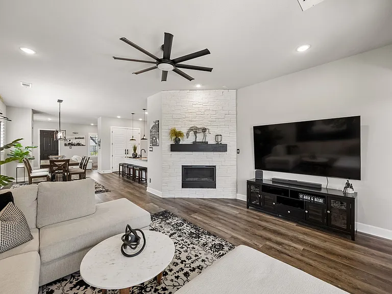 Upgraded fireplace with natural stone and wood mantle