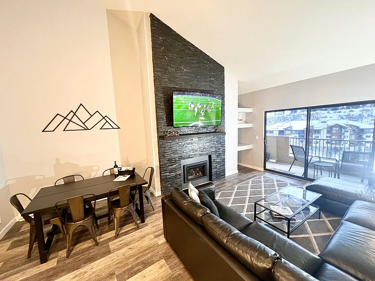 Living room with large sofa-bed sectional and storage chaise lounge, 65 in LED TV, fireplace, balcony with grill and sweeping views of Beaver Creek mountain