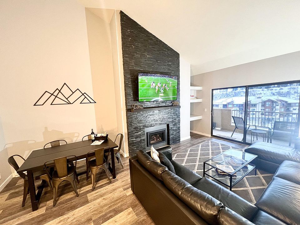 Living room with large sofa-bed sectional and storage chaise lounge, 65 in LED TV, fireplace, balcony with grill and sweeping views of Beaver Creek mountain