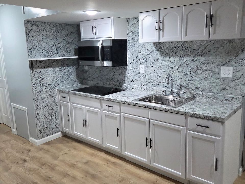 Newly Installed Kitchen with Cabinet Space, Built-in Stovetop, and Microwave