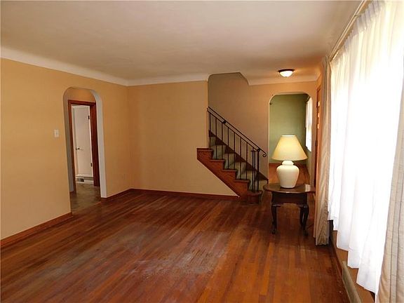 Living room 17x12 features bay window and coved ceiling.