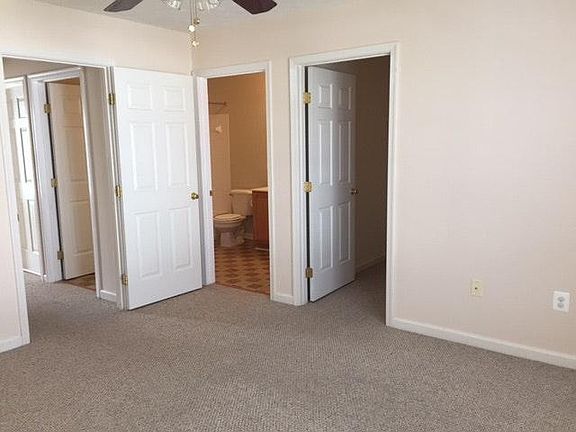 Master bedroom with 9x6 walk in closet and ceiling fan