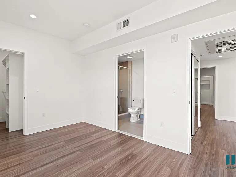 Bedroom with Vinyl Flooring, Recessed Lighting, Walk-In Closet, and Bathroom