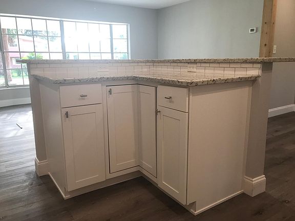 new kitchen island with electrical outlets and more storage with additional lazy susan storage shelves inside. Granite countertops as well.
