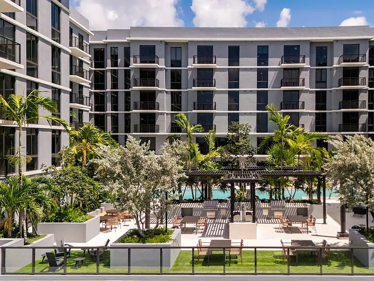 Outdoor lounge with resort-style pool, BBQ grills, and outdoor lounge