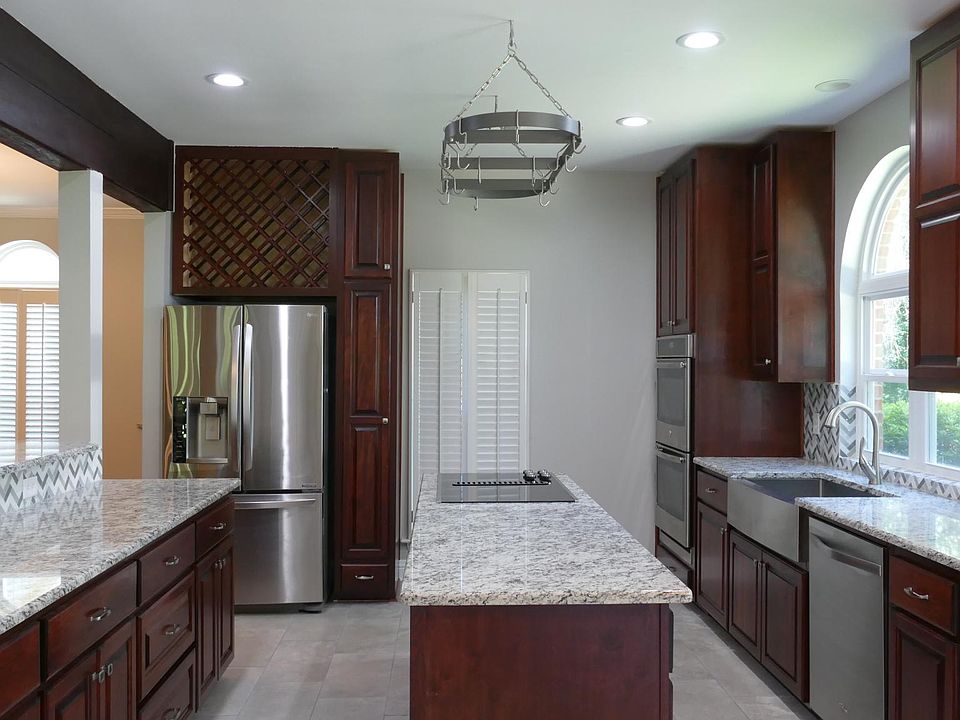 Amazing kitchen with double wall ovens, two sinks, spacious french door refrigerator, eat at bar (barstools included), and loads of counter space!