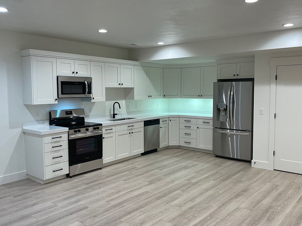 Kitchen with stainless appliances, fridge with water and icemaker, under counter lighting