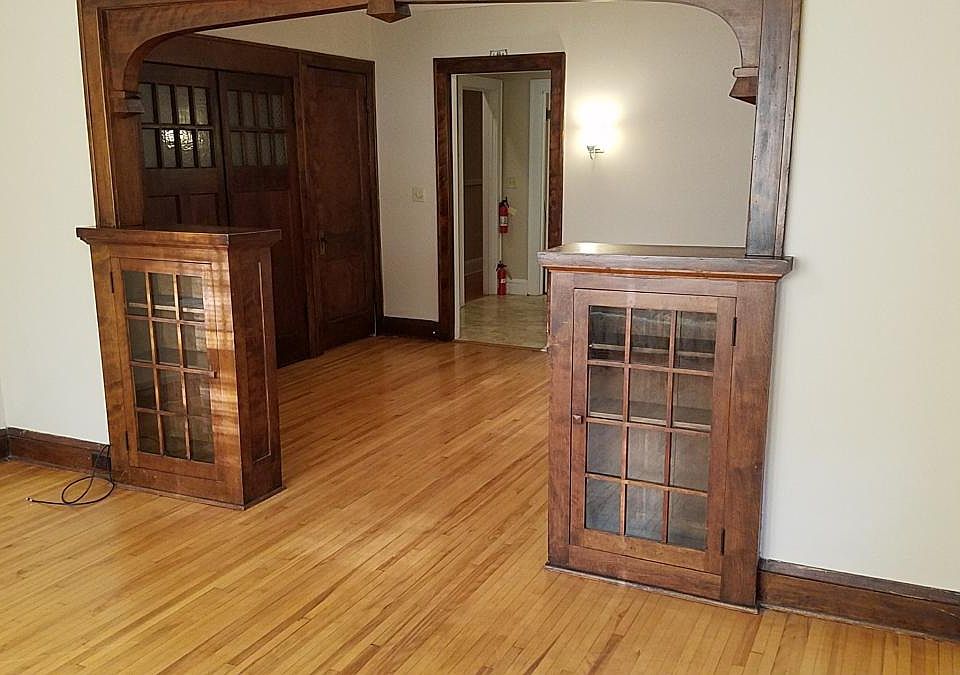 Looking toward DR and door to kitchen. Built-in display cases. Hardwood floors.