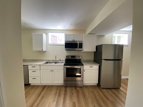 Bright kitchen that connects to living room. Dishwasher and brand new fridge.