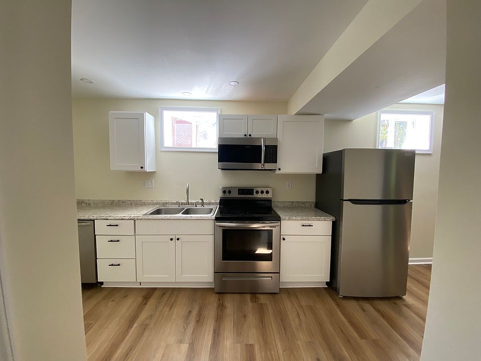 Bright kitchen that connects to living room. Dishwasher and brand new fridge.