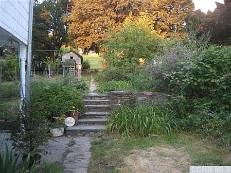 Large lot with private backyard features berry bushes & fruit trees.
