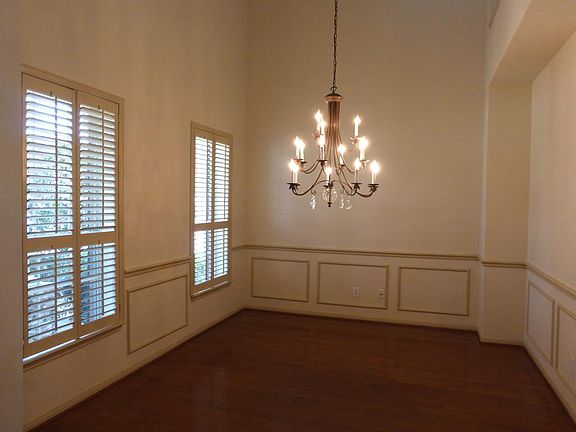 2 Story Breathtaking Formal DIning with Upgraded Light Fixture Hardwoods and Plantation Shutters