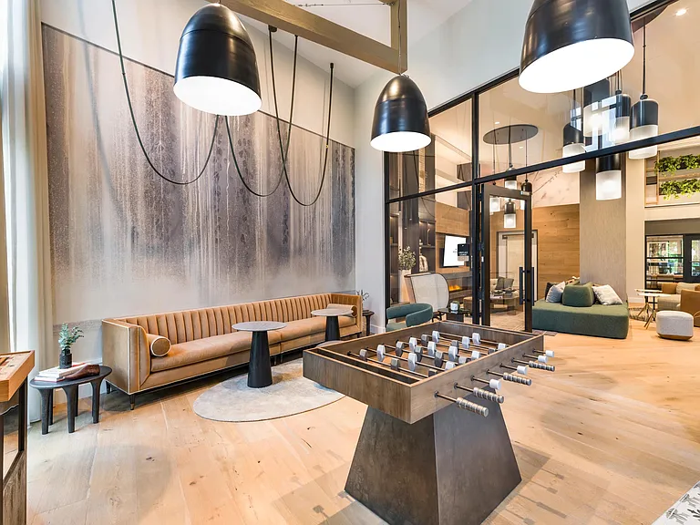 Unwind in the modern resident lounge, complete with stylish seating and a foosball table for casual fun.