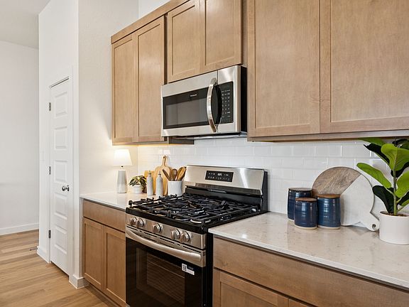 Kitchen in the Diamond home plan by Trophy Signature Homes - REPRESENTATIVE PHOTO