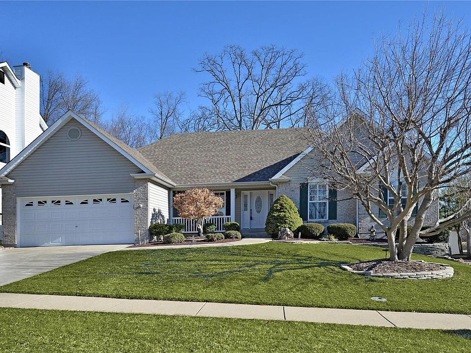 Brick & Vinyl Siding - Covered porch - Professionally landscaped. Wooded lot.Sidewalk runs from front to back patio on left side of house