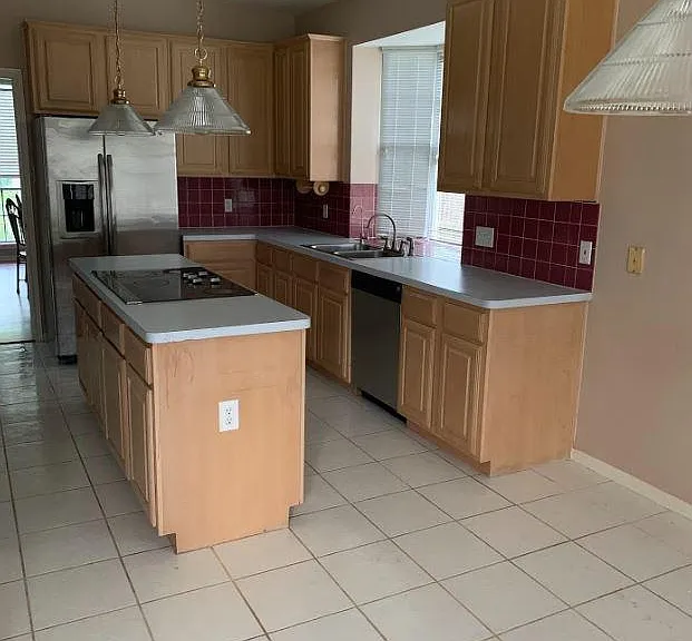 Island kitchen with stainless GE appliances