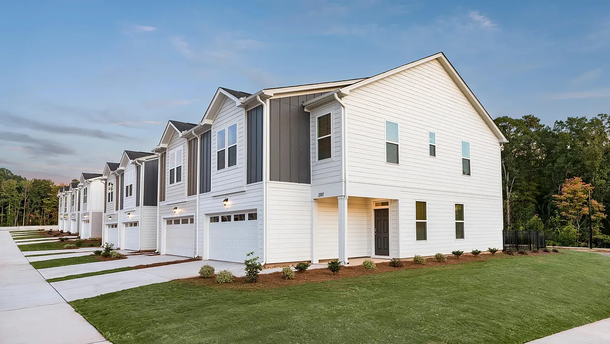 Modern townhome exteriors at Amavi Brier Creek, offering refined living in Durham with convenient access to Brier Creek's shopping, dining, and commuter routes. - Amavi Brier Creek