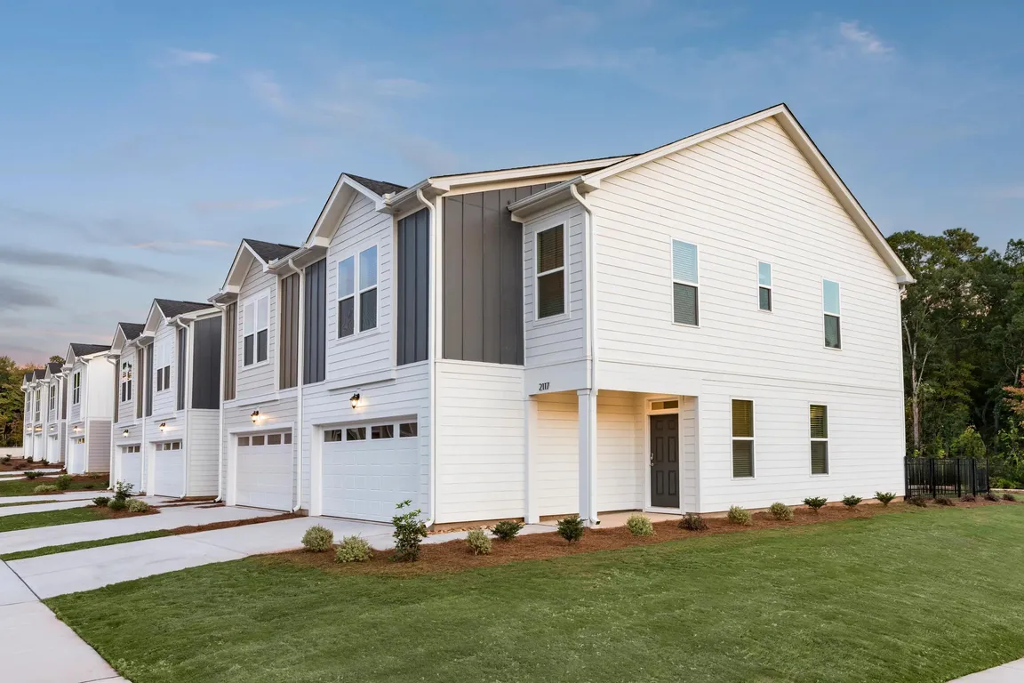 Modern townhome exteriors at Amavi Brier Creek, offering refined living in Durham with convenient access to Brier Creek's shopping, dining, and commuter routes.
