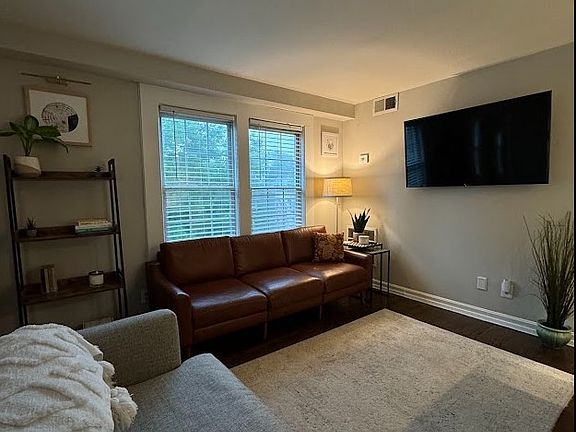 Cozy living room with TV wallmount included for easy set up and no visible cables or wires.