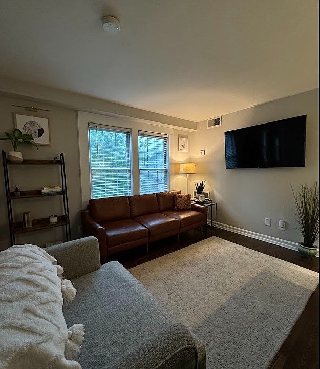 Cozy living room with TV wallmount included for easy set up and no visible cables or wires.