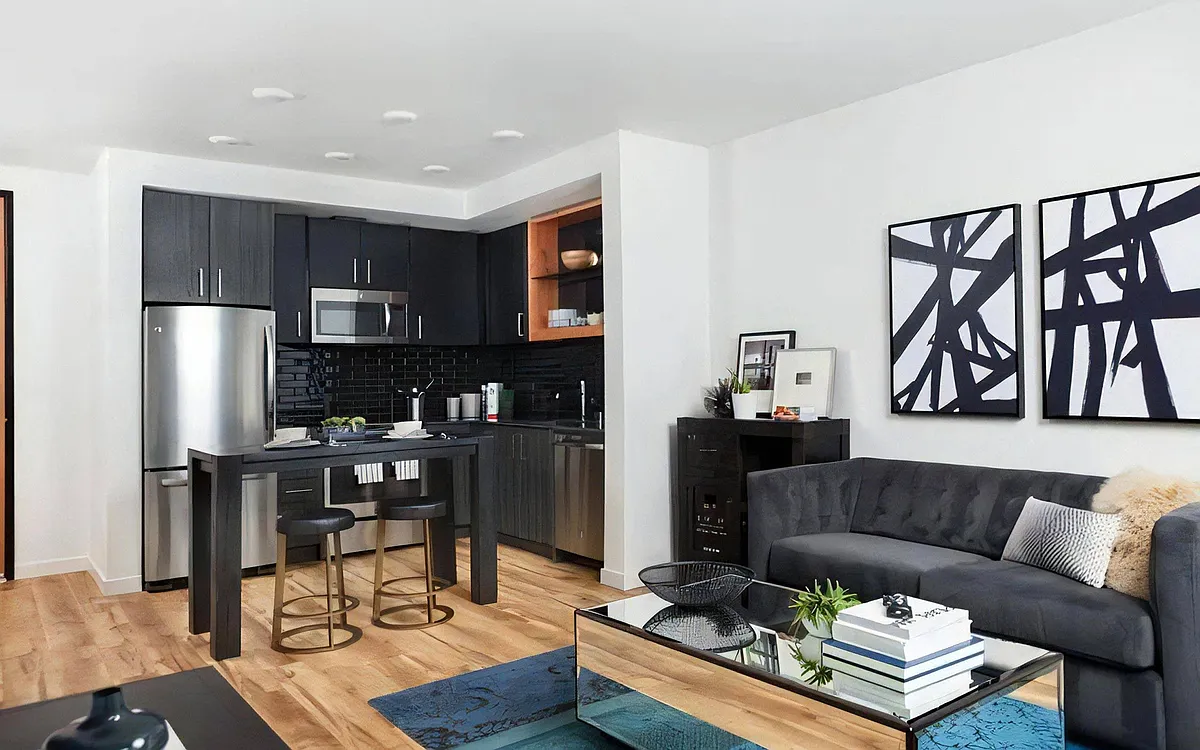 Shared Living Space Featuring Lounge, Kitchen Island, and Dining Zone - Pike Motorworks