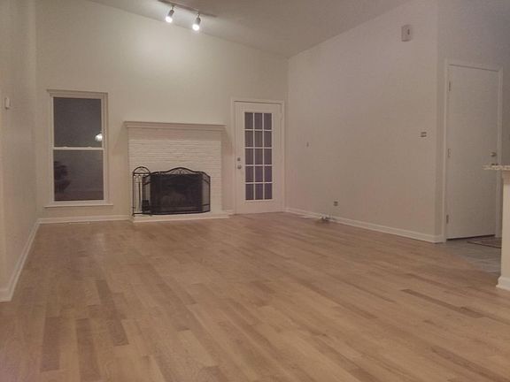 Spacious great room with vaulted ceiling, new hardwood floor