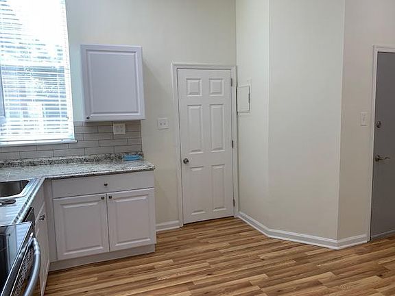Kitchen Area with Door to Bathroom and open living room area