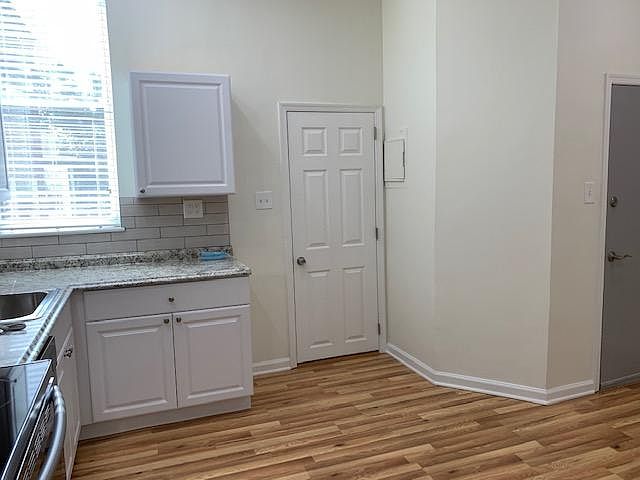 Kitchen Area with Door to Bathroom and open living room area