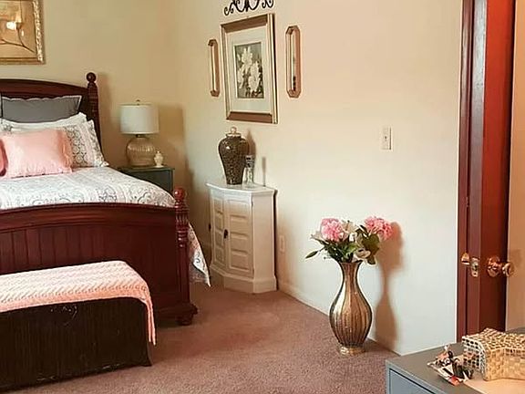 Large bedroom with walk-in closest and room for a vanity or desk.