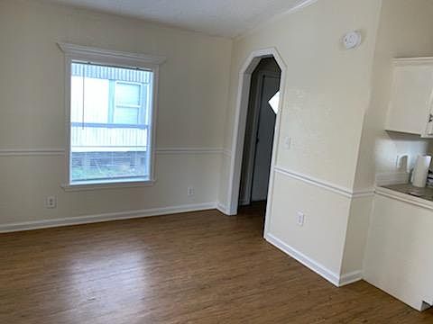 Dining area off of kitchen which leads into roomy laundry area and back door