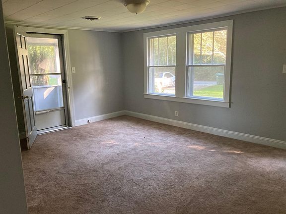 Living room has new double pane windows and 2" blinds (not shown). Door on left opens to screened porch.