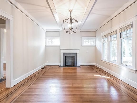 Huge living room with hand nailed original ornate hardwoods