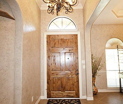 Foyer with beautiful knotty alder wood doors.