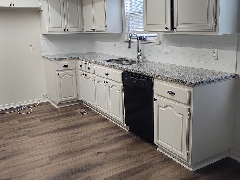 Updated kitchen with granite countertop , sink and fixtures.
