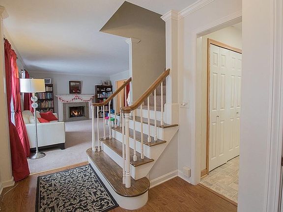 First floor foyer with coat closet, half bath and access to the formal living room, stairs to 2nd level and eat-in kitchen.