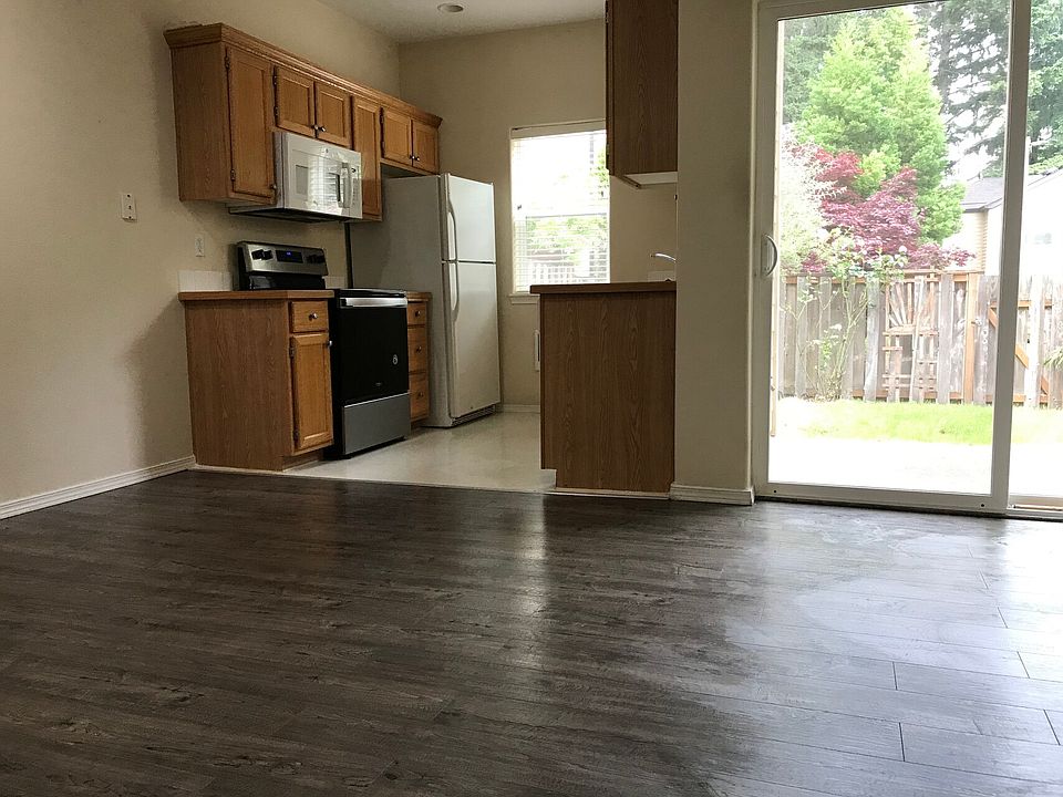 Kitchen after hardwood install and new refrigerator in 2023