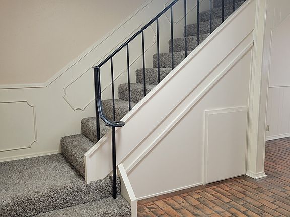 Stairway off the entry, extra storage under the stairs.