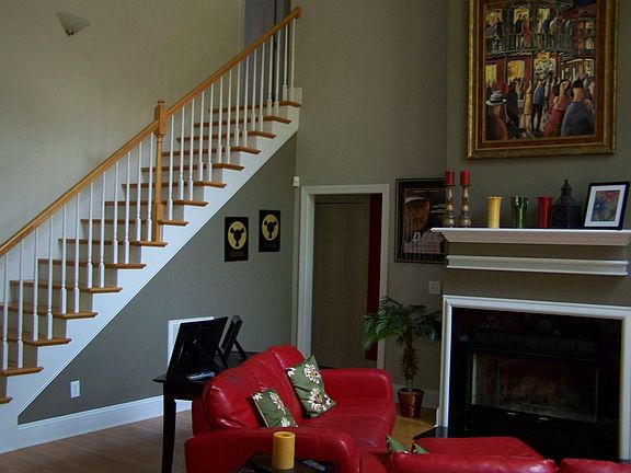 Wood burning fireplace with heightened ceilings.