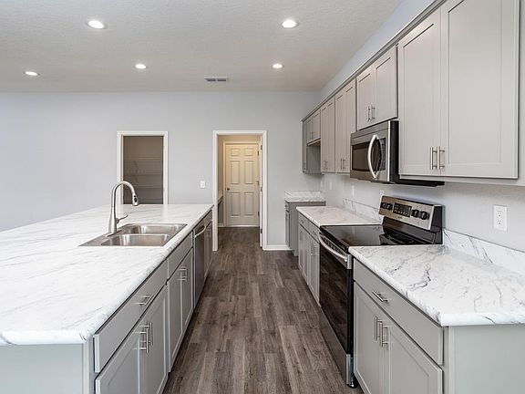 Open kitchen with Samsung SS appliances not pictured - New home for sale in Lake Alfred, FL. Photo