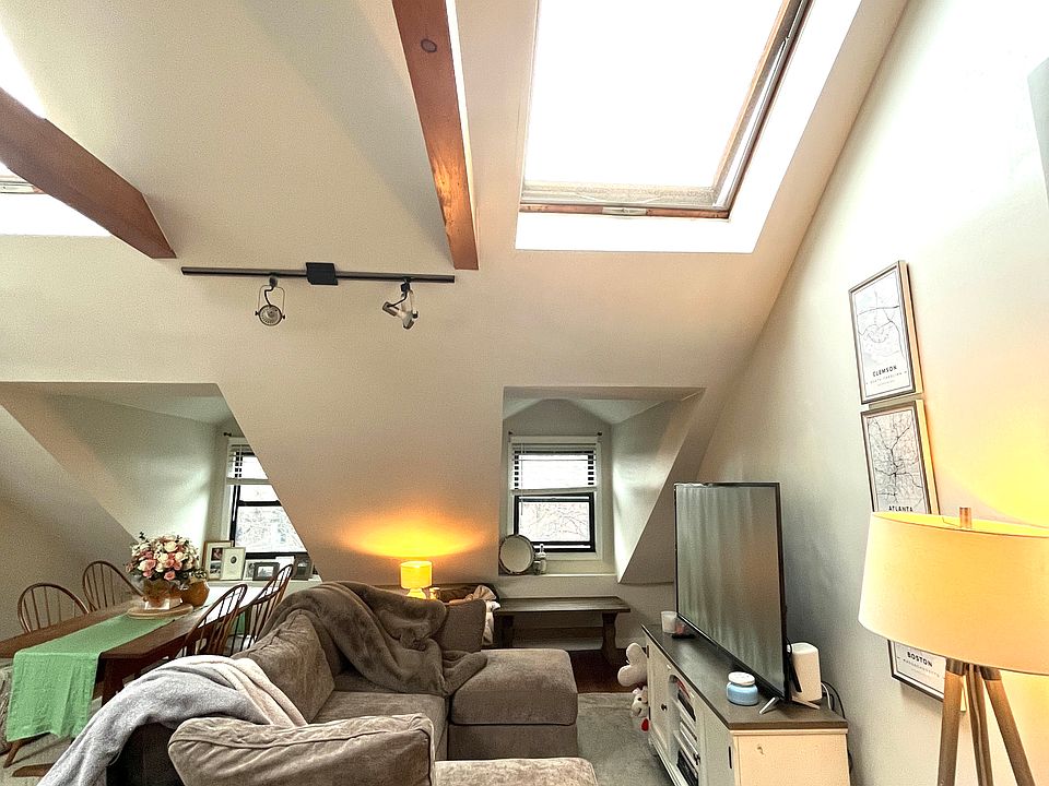 Living room area with vaulted ceilings and skylights