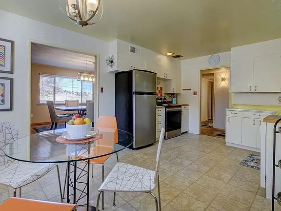 The colorful kitchen features an ideal breakfast nook and coffee cart.