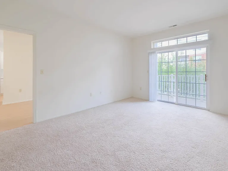 Carpeted Bedroom with Balcony