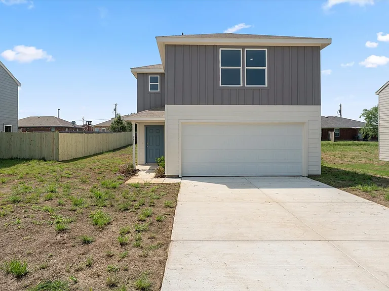 Contemporary exterior with two-tone siding, an attached garage, and a concrete driveway