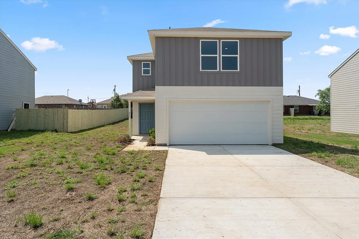 Contemporary exterior with two-tone siding, an attached garage, and a concrete driveway - 293 Victory Dr