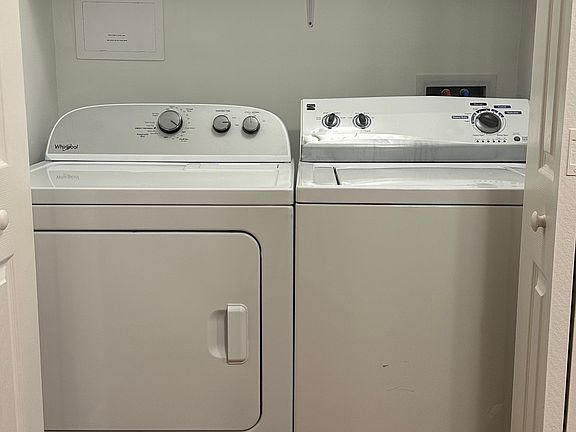 Laundry room is divided from kitchen space with bi-fold doors.