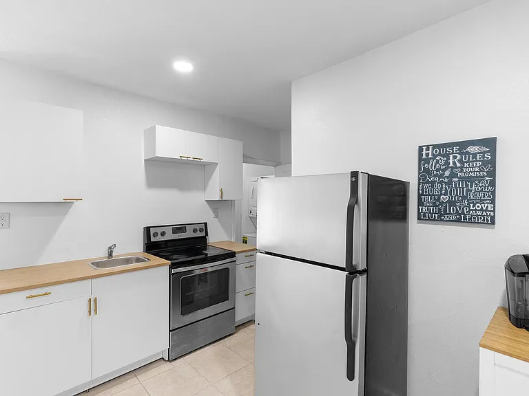 Newly updated kitchen with pots, pans, silverware, dishrack
