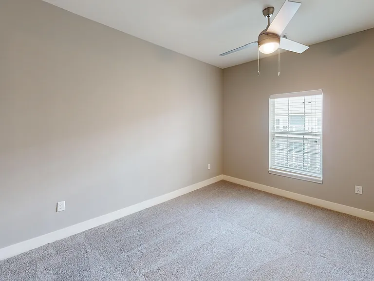 The Kraft's primary bedroom includes a ceiling light and carpeted flooring. The Kraft's primary bedroom includes a ceiling light and carpeted flooring.